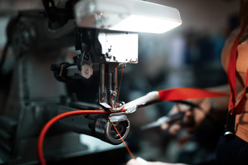 Worker in textile industry sewing