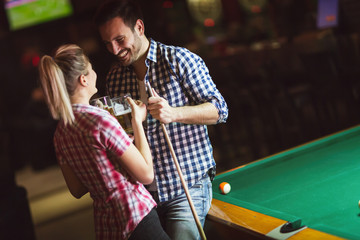 Obraz na płótnie Canvas Couple playing billiards together