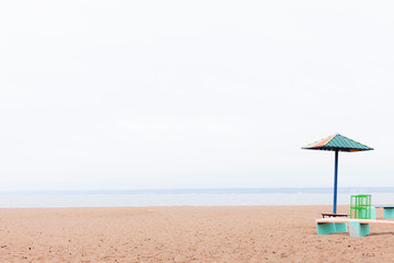 deserted lonely beach sun umbrella