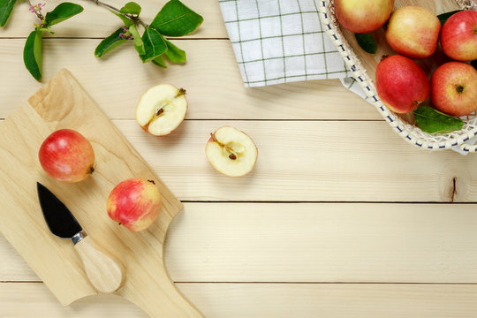 Top view red apple napkin,knift,basket on wooden.
