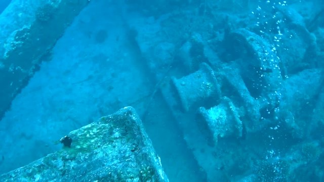 Swimming slowly over the top of Capstans the Main Mast and the entrance to the Bridge of the SS Thistlegorm Ship Wreck in the Red Sea