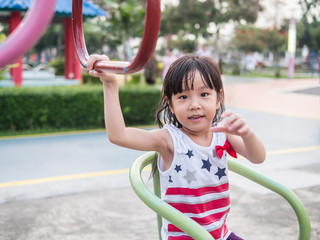 Happy asian baby child playing on playground