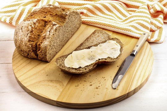 irish soda bread with creamy irish butter on a wooden plate
