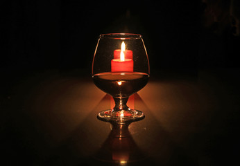 christmas composition photo cognac glass and candle on black background