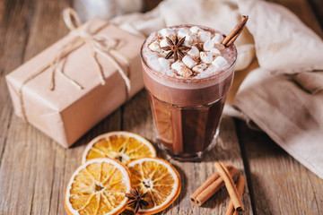 Cocoa or latte or hot chocolate with marshmallow and flavored with cinnamon. On a gray concrete background. Christmas present. Christmas concept. Christmas holiday.