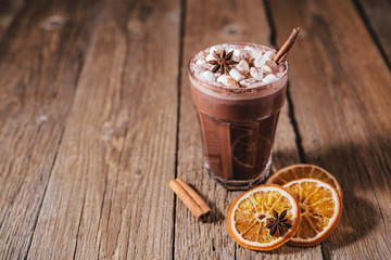 Cocoa or latte or hot chocolate with marshmallow and flavored with cinnamon. On a gray concrete background. Christmas present. Christmas concept. Christmas holiday.