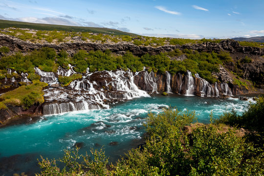 Hraunfossar series of waterfalls formed by rivulets streaming ov © Maygutyak