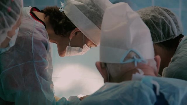 Close-up of medical team in process of performing a surgery in hospital