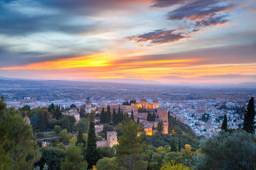 Palace and fortress complex Alhambra with Iglesia de Santa Maria, Palacios Nazaries and Alcazaba during sunset in Granada, Andalusia, Spain - obrazy, fototapety, plakaty