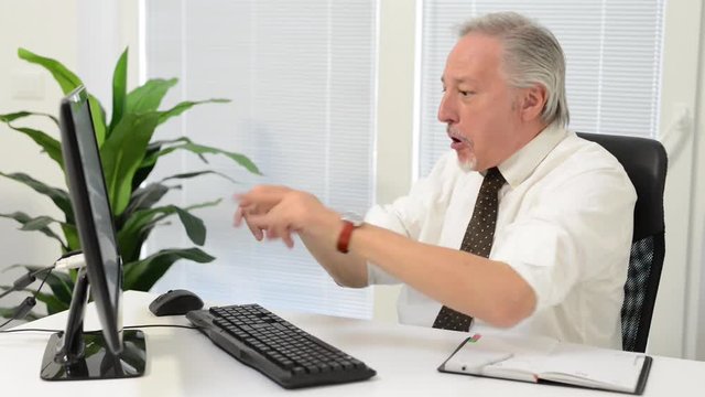     Very happy businessman looking at his computer monitor 