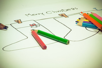 Child draws a pencil colour christmas sock 
Child draws a pencil colour christmas sock on white background