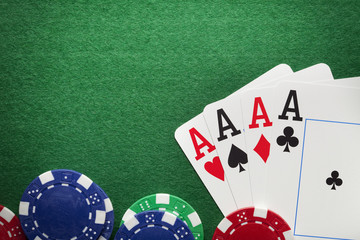 Playing cards, poker chips on green table
