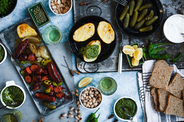 Buffet Dinner Table: Grilled Sausages And Vegetables With Various Snacks