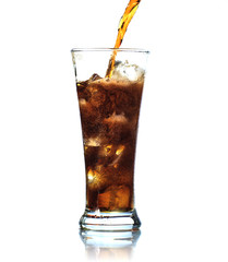 Cola is pouring into glass on white background