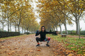 woman practicing kettlebell in the park