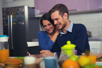 Shot of loving young couple in kitchen by breakfast 