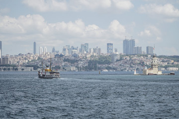 Ferry passes The Maiden's Tower on sea in Istanbul, Turkey