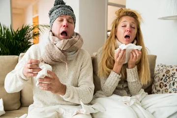 Fotobehang Sick couple catch cold. Man and woman sneezing, coughing, got flu, having runny nose. © Suzi Media 