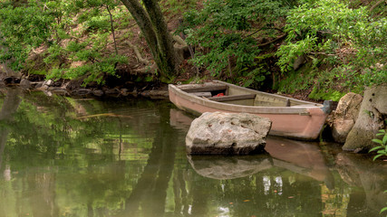 Fototapeta na wymiar Classic old wood boat in a pond