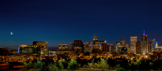 Beautiful view of Denver skyline with moon at night - obrazy, fototapety, plakaty