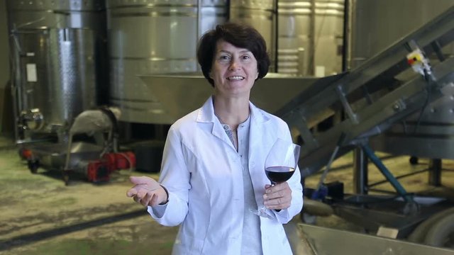 Expert examines equipment at winery and writes down remarks