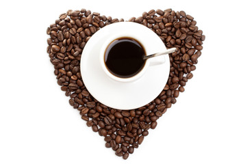 white cup of coffee on beans as a heart