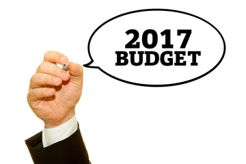 Hand writing Budget 2017 with a marker on a transparent wipe board.