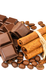 Dark chocolate bar, cubes, cinnamon sticks and coffee beans isolated on white background.