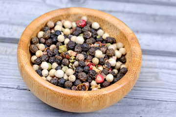 Mosaic peppercorns in a bamboo bowl