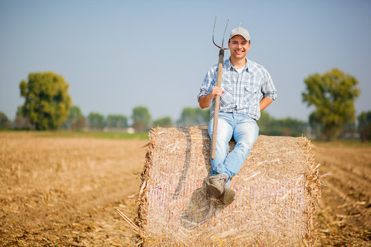 Farmer sitting on a hay bale