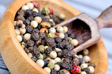 Colorful peppercorns in a bowl and scoop