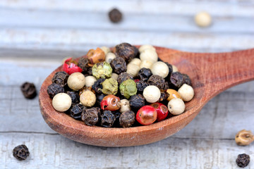Wooden spoon with colorful peppercorns
