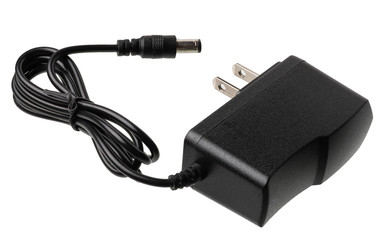 Black charger isolated on white background. The charger has American plug socket
