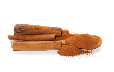 Cinnamon sticks,powder and wooden spoon isolated on white background