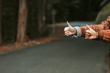hands hitchhike signal