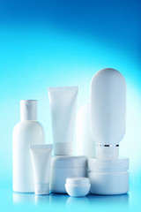 White cosmetic bottles on a blue background