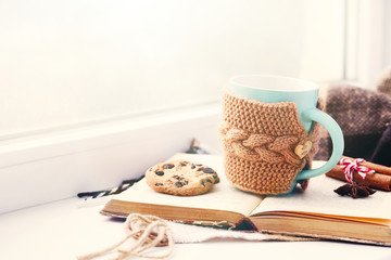 Cup of coffee on windowsill near the window