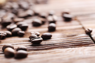 Roasted coffee beans on a brown wooden table