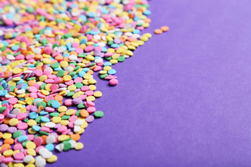 Colorful sprinkles on the purple background