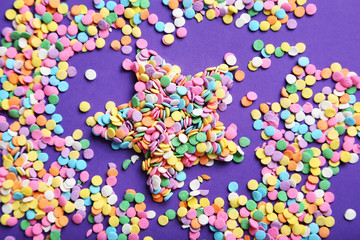 Colorful sprinkles on the purple background