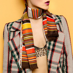 Lady in style checkered coat and striped scarf. The combination