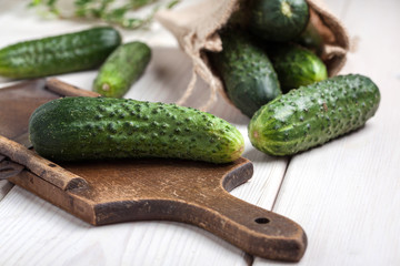 Raw cucumbers on cutting board.