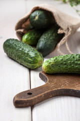 Raw cucumbers on cutting board.