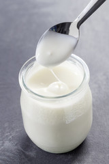 yogurt with spoon isolated on white background