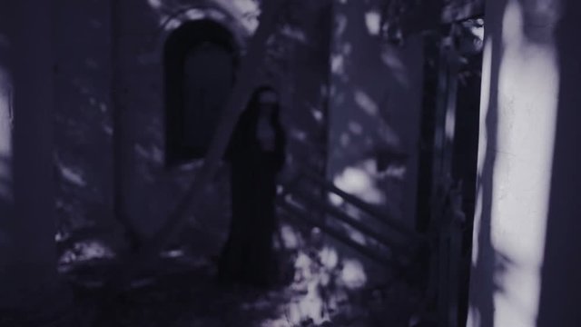 zombie nun. devilish woman in nun costume walking around the temple. halloween