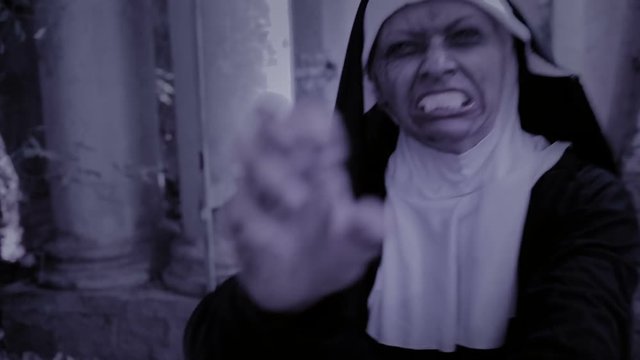 zombie nun. devilish woman in nun costume walking around the temple. halloween