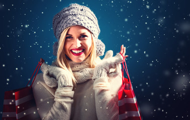 Happy young woman holding shopping bags