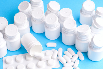 Many pills and tablets isolated on light blue background