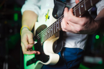 Musician live plays guitar in the room
