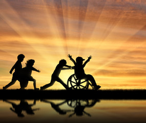 Happy boy in wheelchair playing with children and their reflection in water